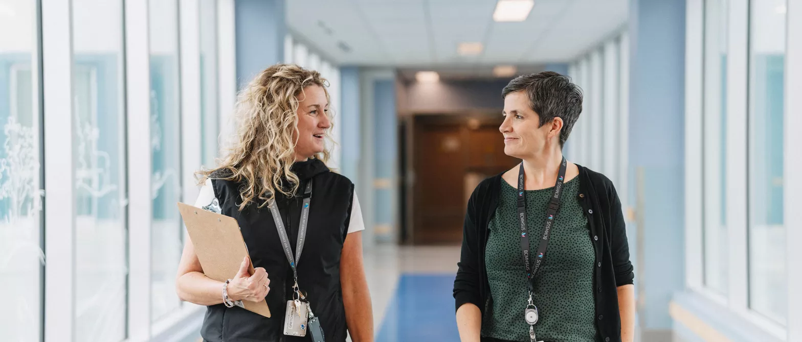Health professionals walking down a hallway