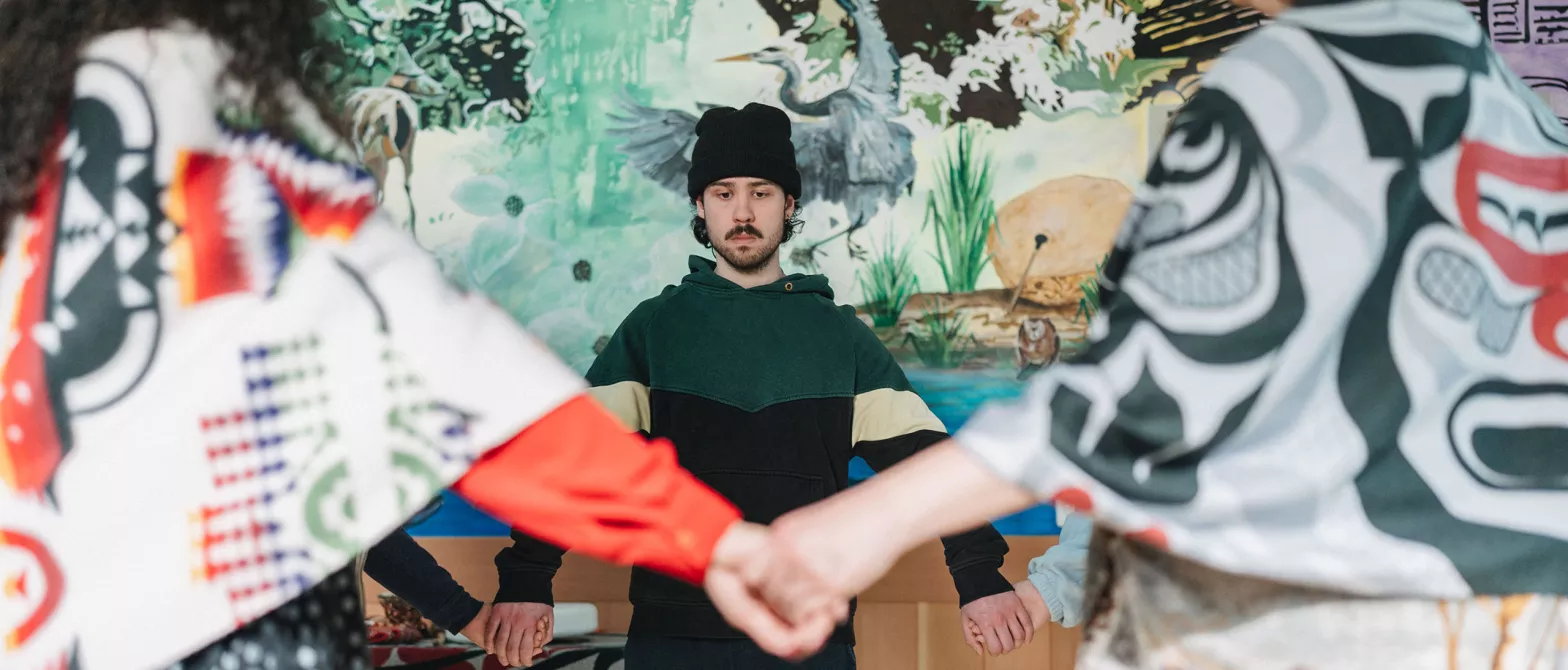 Indigenous circle holding hands