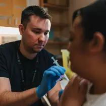 A healthcare worker administering a vaccine to a patient.