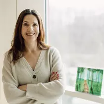 A woman smiles at the camera.