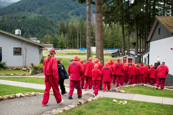 Group of men in red walking through grounds