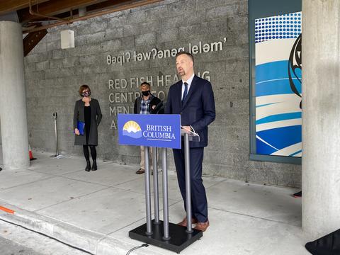 President and CEO David Byres stands at a podium at Red Fish Healing Centre.