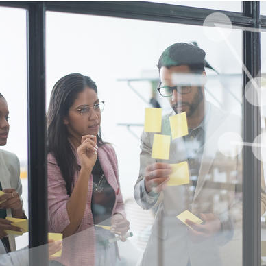 Office staff writing on post-its during a collaboration